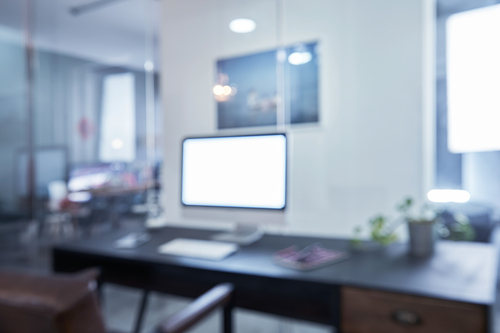 Blurred and defocused office workplace background , for commercial business ads using background .