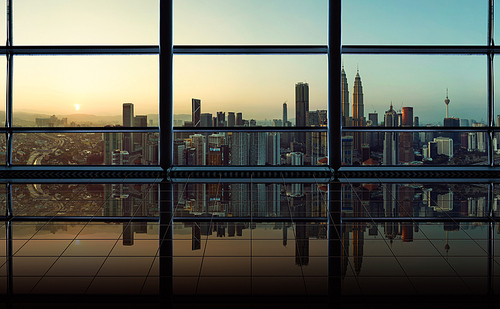 Modern empty and clean office interior with glass windows and city skyline background , early morning scene .