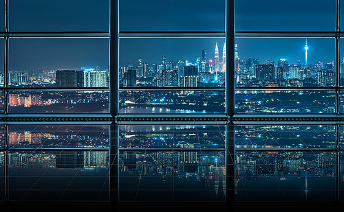 Modern empty and clean office interior with glass windows and city skyline background , night scene .