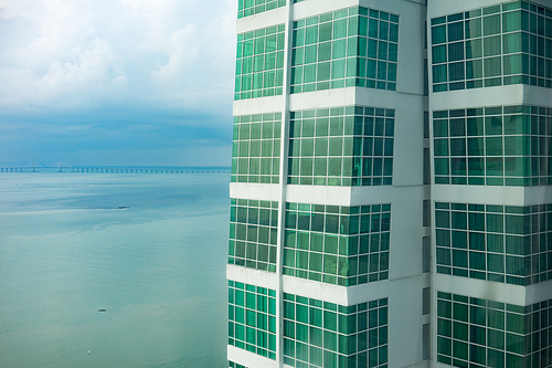 Modern condominium  with patterned glass windows building facades, sea view .