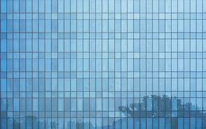 Glass windows of high rise commercial skyscraper building , for business concept background .