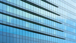 Glass windows of high rise commercial skyscraper building , for business concept background .
