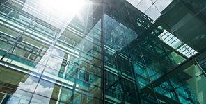 Low angle closeup view of modern green glass facade office building in Kuala Lumpur , Malaysia .
