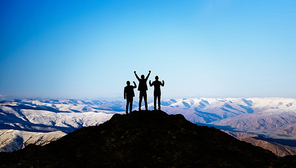 Silhouette of the Business team on top of a mountain . Business Success and Leadership concept.