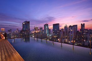 Cityscape sunset view of Bangkok modern office business building and high skyscraper in business district with infinity view swimming pool at Bangkok,Thailand.