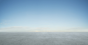 Empty asphalt floor with blue sky .