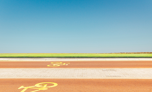Bicycle way with green and blue sky background