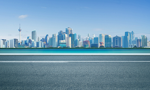 Road with sea and cityscape skyline , morning scene .