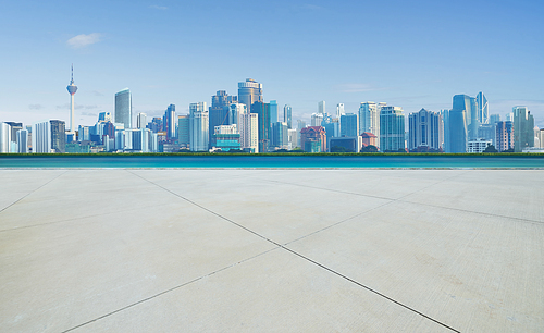 Empty concrete cement floor with sea and cityscape skyline , morning scene .