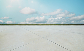 Empty concrete cement floor with green and beautiful cloud sky  , noon scene .