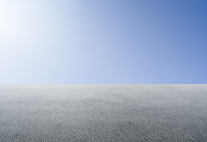 Empty asphalt floor with clear sunny sky background .