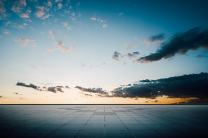 Empty ground floor with beautiful sunset sky .