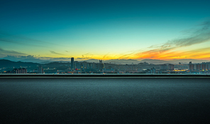 Asphalt empty road side with dramatic orange color sunrise sky background .