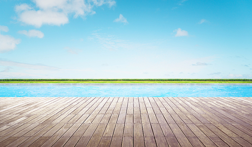 Empty wooden deck with swimming pool , Beautiful minimalist pool side view with  blue sky .