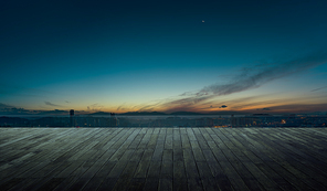 Wooden balcony terrace with early morning sky .