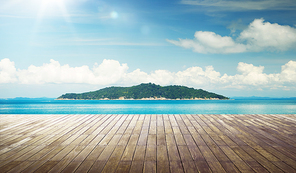 Empty wood jetty floor in front of beautiful afternoon seascape .