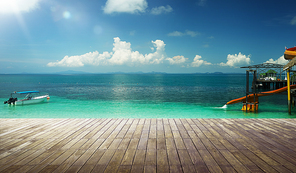 Empty wood jetty floor in front of beautiful afternoon seascape .