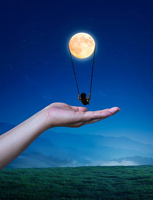 Little girl on a swing in the form of the moon