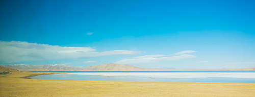 Beautiful lake and yellow fields scenery in Tibet .