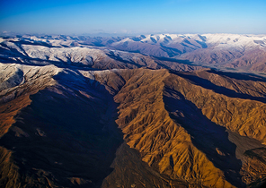 Beautiful scenery in Tibet with yellow hill and snowscape . aerial view .