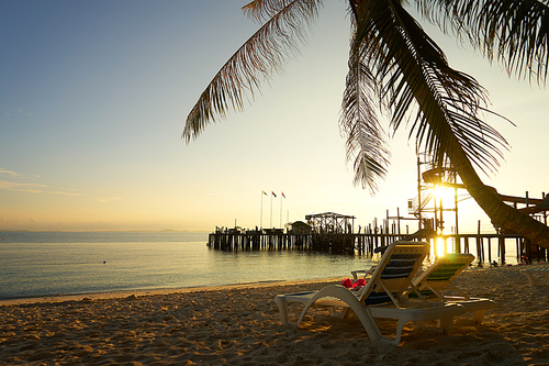 Couple of deck chairs at sunset on Rawa island , Summer travel concept, Malaysia .