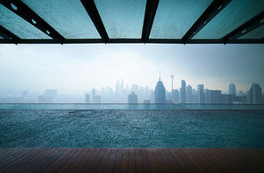 Swimming pool on roof top with beautiful city skyline view,rainingday , kuala lumpur malaysia.