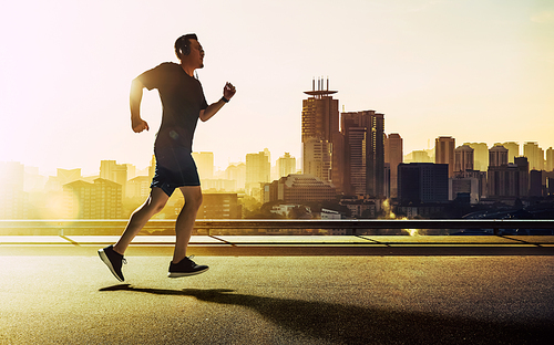 The runner on the urban street be running for exercise .