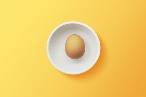 top view of egg in bowl ,orange background