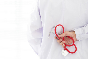 Unknown doctor with stethoscope . Back view .