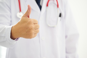 Unknown doctor hands with thumbs up .