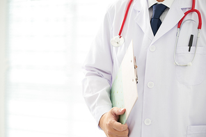 Doctor with a stethoscope and taking notes with bright background .