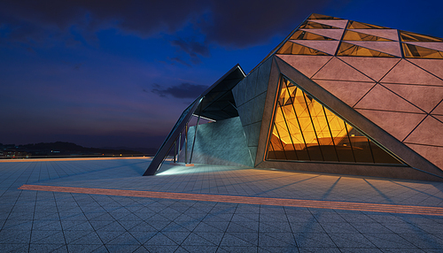 Contemporary triangle shape design modern Architecture building exterior with glass, concrete and steel element. Night scene. Photorealistic 3D rendering.