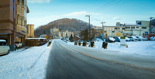 Empty asphalt road with beautiful winter small town