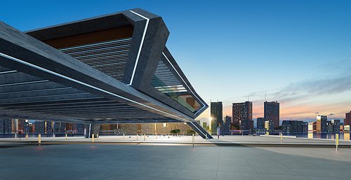 Perspective view of empty concrete floor and modern rooftop building with sunrise cityscape scene.  3d rendering