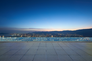 Peaceful city view at dusk with clear skies from an elevated modern terrace