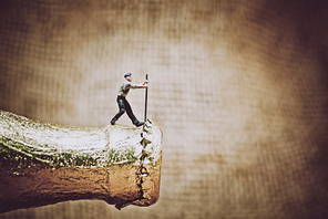 Miniature worker opening a beer bottle. Color tone tuned photo. Macro photo