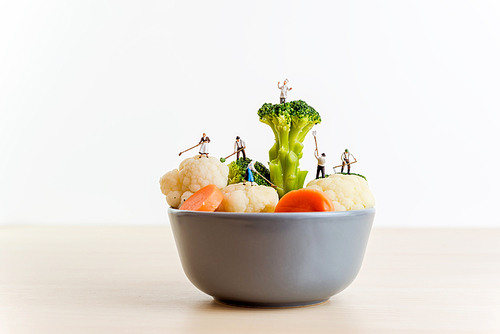 Miniature farmers and a giant bowl of salad