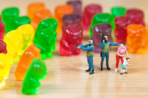 Gummy bear invasion. Harmful/ junk food concept. Macro photo
