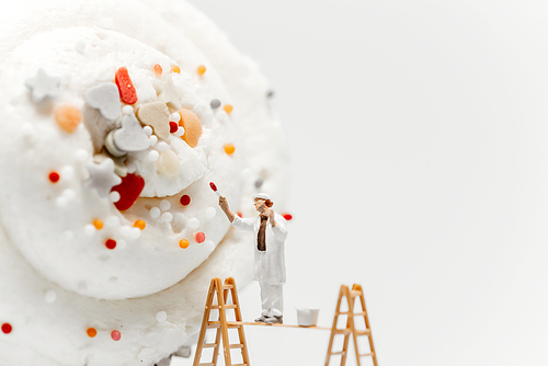 Miniature painter colouring giant cupcake