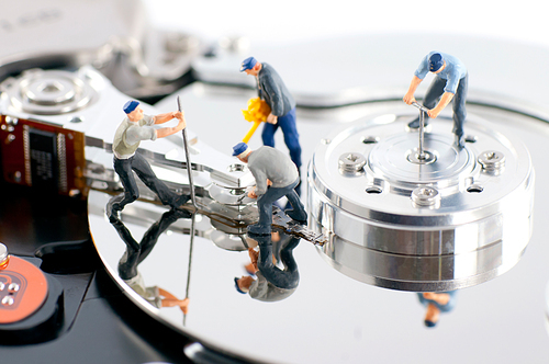 Group of workers repair hard drive. Hard drive repair concept