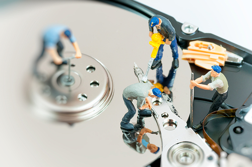 Workers repairing hard drive. Macro photo