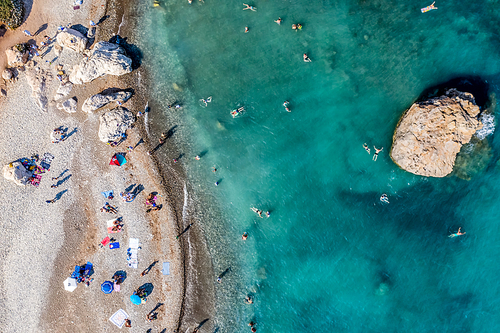 Tourists swimming and sunbathing at th Aphrodite's Rock, Cyprus