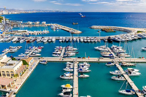 Aerial view of Limassol Marina with boats, piers, villas and resort area