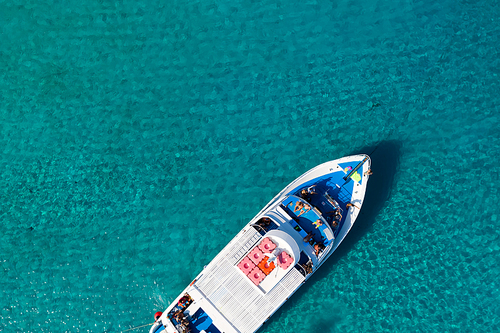 Top view of a yacht in clear blue sea