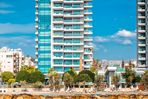 Modern residential buildings and pedestrian walkway along the seafront. Limassol, Cyprus.