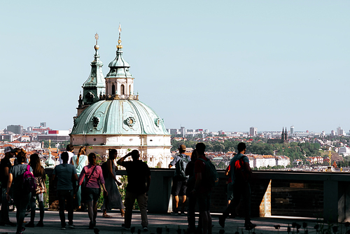Tourists observe the Prague skyline from atop of the Prague Castle garden. Czech Republic