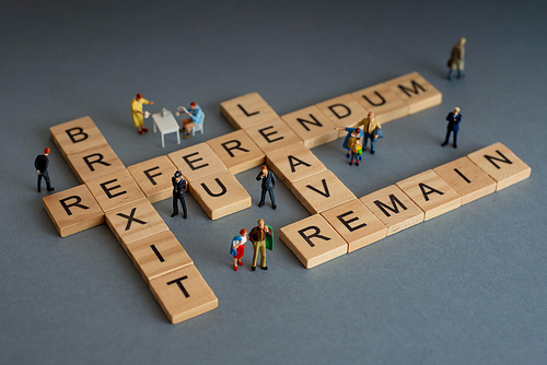 Brexit concept. Various people and Brexit word written on wood blocks