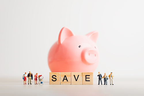 Giant piggy bank and group of casual people. Savings concept