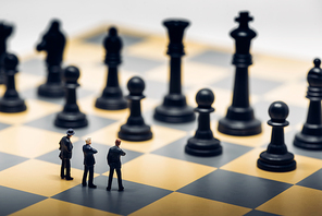 Businessmen on a chessboard. Business strategy concept.