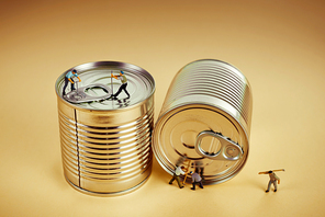 Group of workers opening a tin can with crowbar